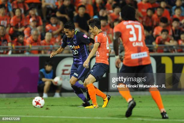 Kosei Shibasaki of Sanfrecce Hiroshima takes on Akimi Barada of Omiya Ardija during the J.League J1 match between Omiya Ardija and Sanfrecce...