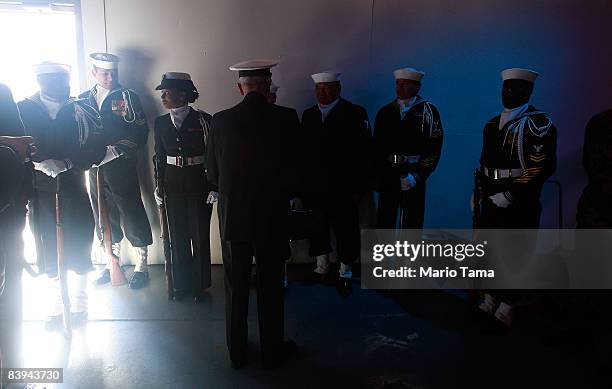 Members of the U.S. Navy honor guard look on after commemorating the 67th anniversary of the attack on Pearl Harbor at the Intrepid Sea, Air & Space...