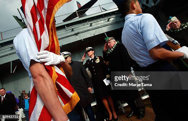 Navy Cmdr. Regina Marengo , retired NYPD Chaplain William G. Kalaidjian and others salute while commemorating the 67th anniversary of the attack on...