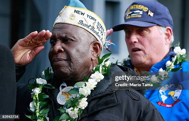 Navy veteran Clark J. Simmons , who was aboard the USS Utah which was sunk during the Pearl Harbor attacks, salutes while commemorating the 67th...