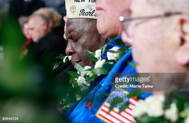 Navy veteran Clark J. Simmons , who was aboard the USS Utah which was sunk during the Pearl Harbor attacks, bows his head while commemorating the...