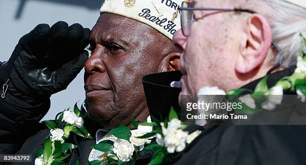 Navy veteran Clark J. Simmons , who was aboard the USS Utah which was sunk during the Pearl Harbor attacks, salutes while commemorating the 67th...