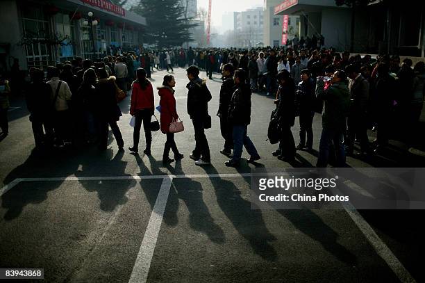 University students line up to enter a job fair of nationwide meteorological departments for graduating students on December 7, 2008 in Beijing,...
