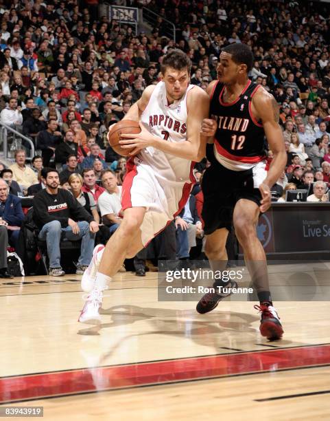Andrea Bargnani of the Toronto Raptors drives past defender LaMarcus Aldridge of the Portland Trail Blazers on December 7, 2008 at the Air Canada...