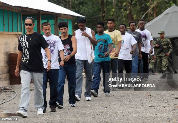 Nine of seventeen members of the National Liberation Army march after surrendering their AK-47 to the Colombian Army on December 7 in Quibdo,...