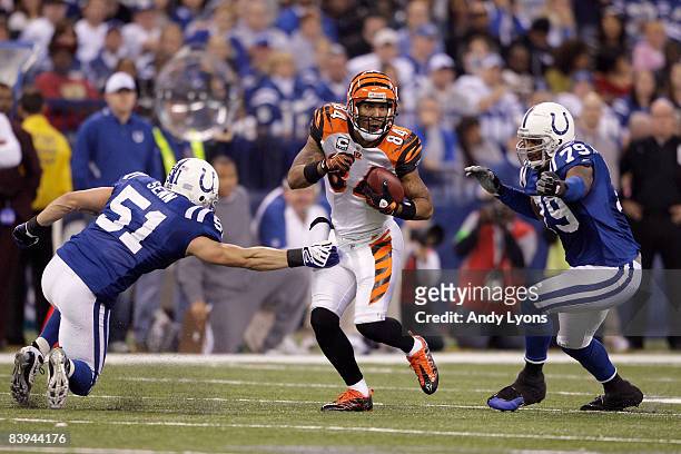 Houshmanzadeh of the Cincinnati Bengals runs for yards after the catch against Jordan Senn and Raheem Brock of the Indianapolis Colts at Lucas Oil...