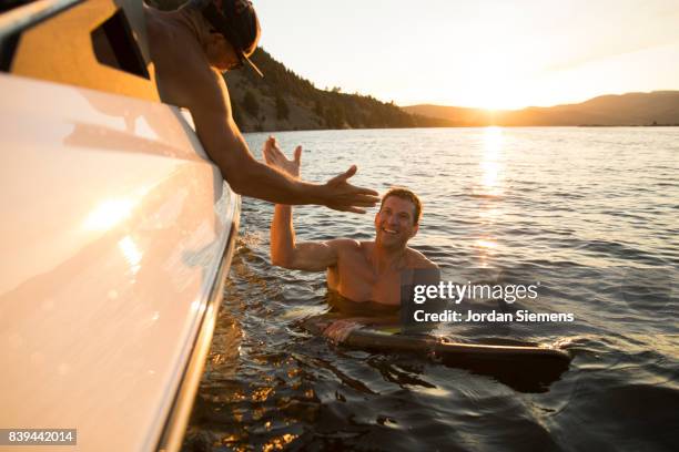 a group of freinds enjoying a day at the lake - wakeboarding stock pictures, royalty-free photos & images