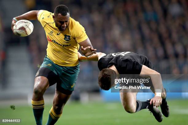 Tevita Kuridrani of the Wallabies is tackled by Beauden Barrett of the All Blacks during The Rugby Championship Bledisloe Cup match between the New...