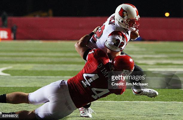 Brock Bolen of the Louisville Cardinals runs in a fourth quarter touchdown against Ryan D'Imperio of the Rugers Scarlet Knights at Rutgers Stadium on...