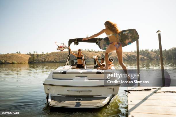 a group of freinds enjoying a day at the lake - motorboat stockfoto's en -beelden