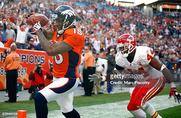 Wide receiver Brandon Marshall of the Denver Broncos catches a touchdown pass in front of Jarrad Page of the Kansas City Chiefs during the second...