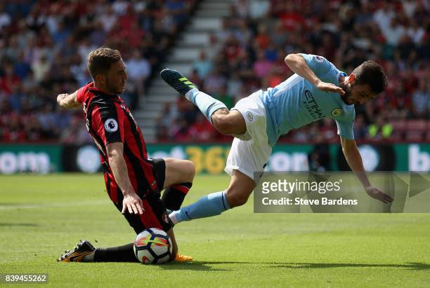 Dan Gosling of AFC Bournemouth fouls Bernardo Silva of Manchester City during the Premier League match between AFC Bournemouth and Manchester City at...