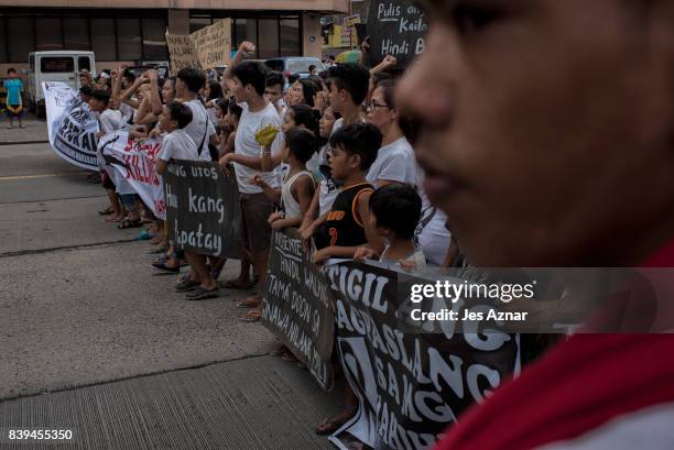 Protesters march on the street shouting slogans against the police and to call for justice on August 26, 2017 in Caloocan city, Philippines. More...