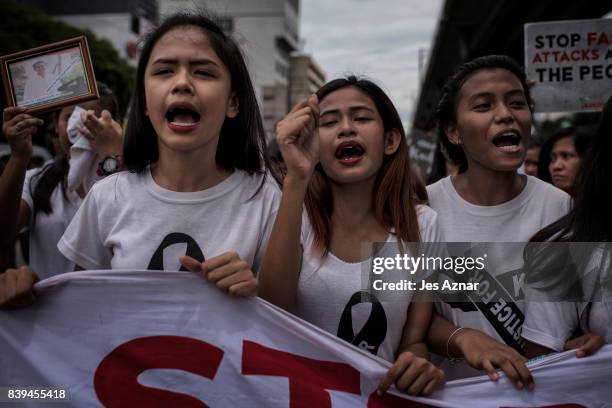 Protesters march on the street shouting slogans against the police and to call for justice on August 26, 2017 in Caloocan city, Philippines. More...