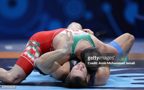 Amir Mohsen Mohammadi of Iran in action against Aliaksandr Hushtyn of Belarus during World Wrestling Championships in qualification freestyle Seniors...