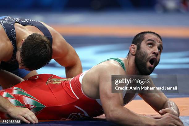 Amir Mohsen Mohammadi of Iran in action against Aliaksandr Hushtyn of Belarus during World Wrestling Championships in qualification freestyle Seniors...