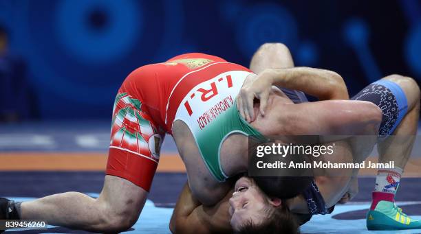 Amir Mohsen Mohammadi of Iran in action against Aliaksandr Hushtyn of Belarus during World Wrestling Championships in qualification freestyle Seniors...