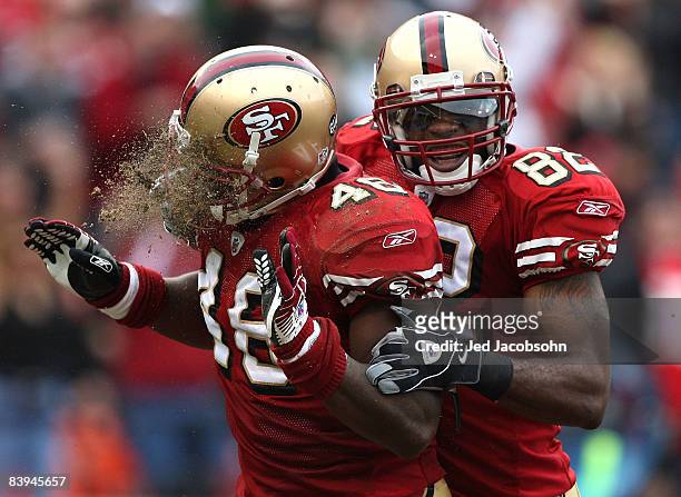 Delanie Walker of the San Francisco 49ers celebrates with teammate Bryant Johnson after scoring a touchdown that was negated by a penalty against the...