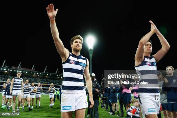 Tom Lonergan of the Cats and Andrew Mackie wave to fans after their win during the round 23 AFL match between the Geelong Cats and the Greater...