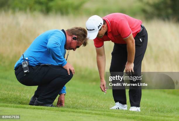 Steve Webster of England is given a ruling by referee Neil Briggs on the 7th hole during day three of the Made in Denmark at Himmerland Golf & Spa...