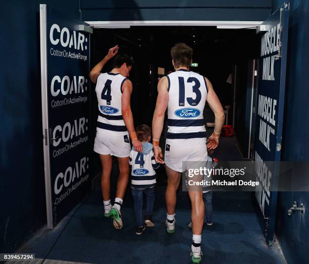 Tom Lonergan of the Cats and Andrew Mackie wave to fans after their win during the round 23 AFL match between the Geelong Cats and the Greater...