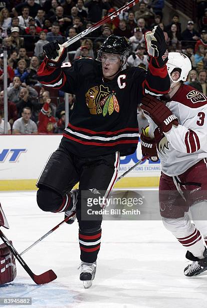 Jonathan Toews of the Chicago Blackhawks raises his arms up in celebration seconds after scoring the 2nd goal of the night against the Phoenix...