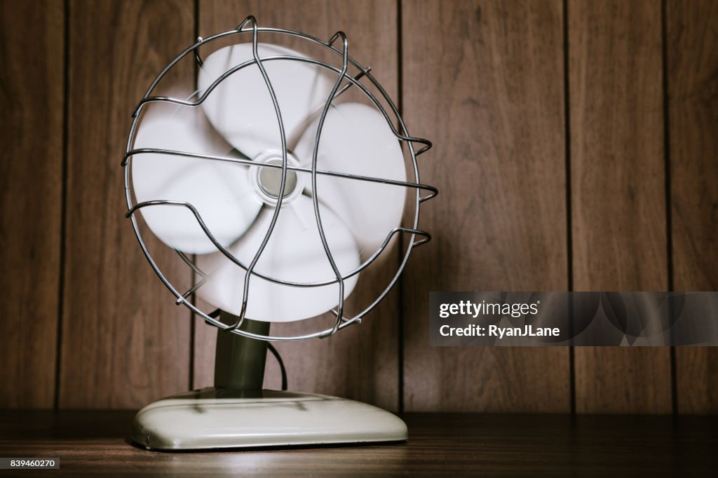 Retro Electric Fan and Wood Paneling