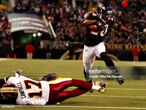 Safety Ed Reed of the Baltimore Ravens returns a fumble for a touchdown as he leaps over quarterback Jason Campbell of the Washington Redskins...