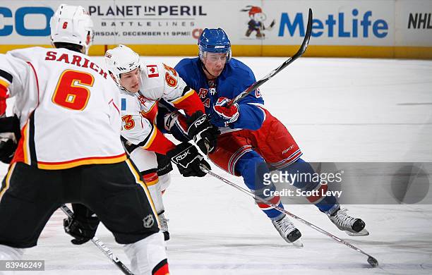 Lauri Korpikoski of the New York Rangers defends against Warren Peters of the Calgary Flames during the first period on December 7, 2008 at Madison...