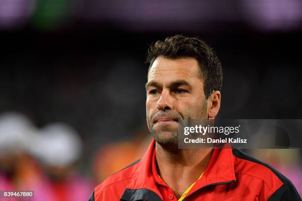 Suns interim head coach Dean Solomon walks from the field at three quarter time during the round 23 AFL match between the Port Adelaide Power and the...