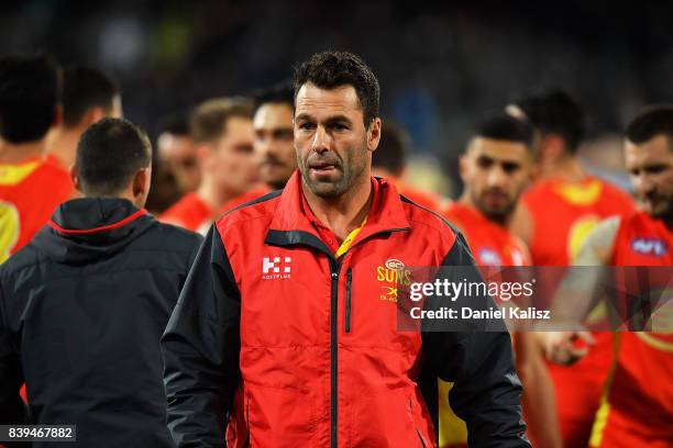 Suns interim head coach Dean Solomon walks from the field at three quarter time during the round 23 AFL match between the Port Adelaide Power and the...