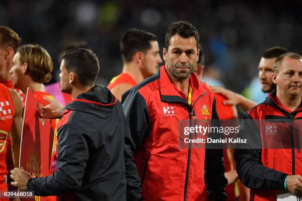 Suns interim head coach Dean Solomon walks from the field at three quarter time during the round 23 AFL match between the Port Adelaide Power and the...