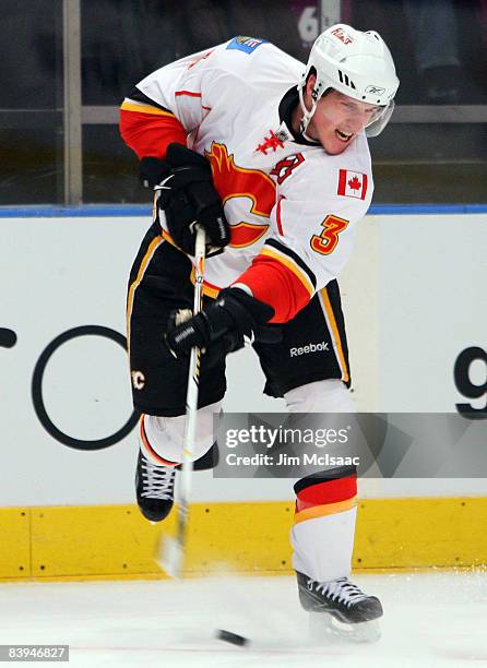 Dion Phaneuf of the Calgary Flames shoots the puck against the New York Rangers on December 7, 2008 at Madison Square Garden in New York City.