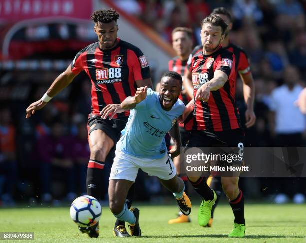 Tyrone Mings of AFC Bournemouth and Harry Arter of AFC Bournemouth foul Raheem Sterling of Manchester City during the Premier League match between...