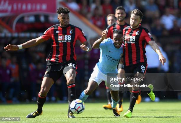 Tyrone Mings of AFC Bournemouth and Harry Arter of AFC Bournemouth foul Raheem Sterling of Manchester City during the Premier League match between...