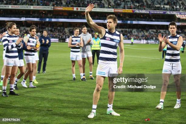 Tom Lonergan of the Cats and Andrew Mackie wave to fans after their win during the round 23 AFL match between the Geelong Cats and the Greater...