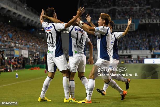 Shun Nagasawa of Gamba Osaka celebrates scoring his side's second goal with his team mates during the J.League J1 match between Sagan Tosu and Gamba...