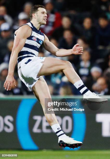 Sam Menegola of the Cats kicks the ball during the round 23 AFL match between the Geelong Cats and the Greater Western Sydney Giants at Simonds...