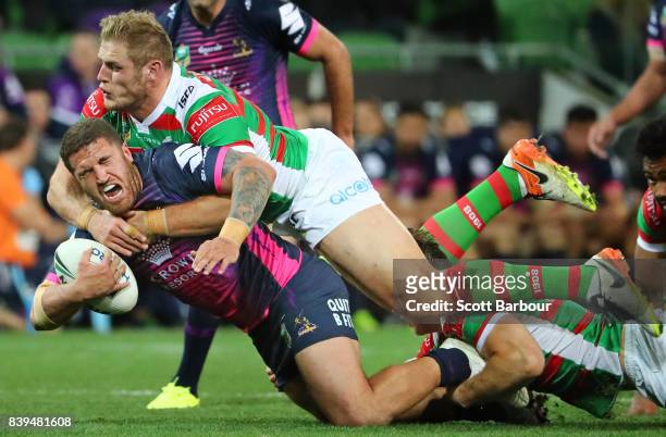 Kenneath Bromwich of the Storm is tackled by Thomas Burgess of the Rabbitohs during the round 25 NRL match between the Melbourne Storm and the South...
