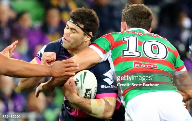 Dale Finucane of the Storm is tackled high by Sam Burgess of the Rabbitohs during the round 25 NRL match between the Melbourne Storm and the South...