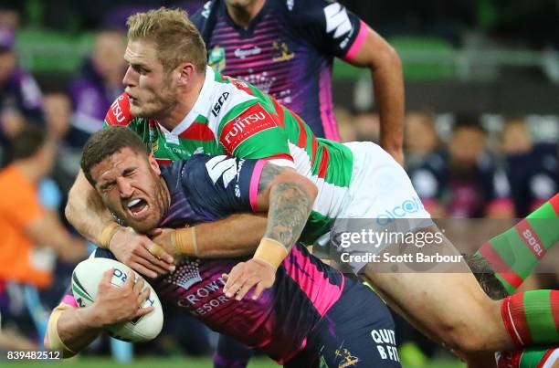 Kenneath Bromwich of the Storm is tackled by Thomas Burgess of the Rabbitohs during the round 25 NRL match between the Melbourne Storm and the South...