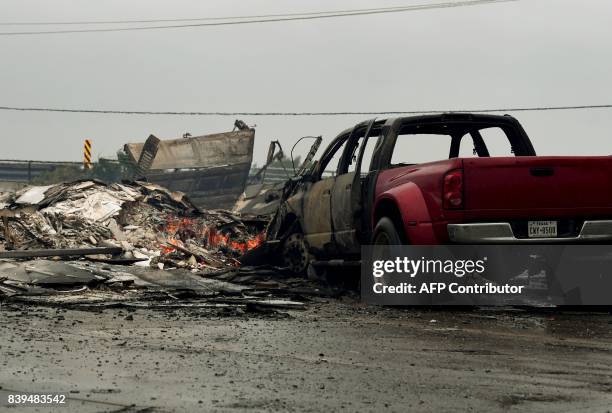 Burnt out house and cars that caught fire are seen after Hurricane Harvey hit Corpus Christi, Texas on August 26, 2017. Hurricane Harvey slammed into...