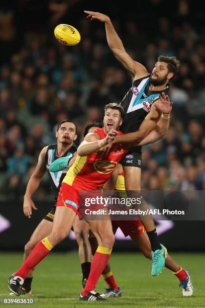 Keegan Brooksby of the Suns competes with Paddy Ryder of the Power during the 2017 AFL round 23 match between the Port Adelaide Power and the Gold...