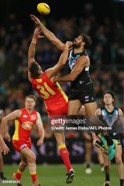 Keegan Brooksby of the Suns competes with Paddy Ryder of the Power during the 2017 AFL round 23 match between the Port Adelaide Power and the Gold...