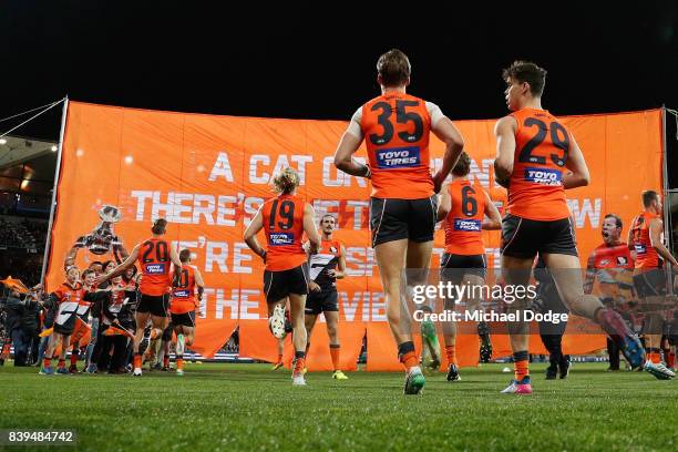 Phil Davis of the Giants waits for players to run to the banner during the round 23 AFL match between the Geelong Cats and the Greater Western Sydney...
