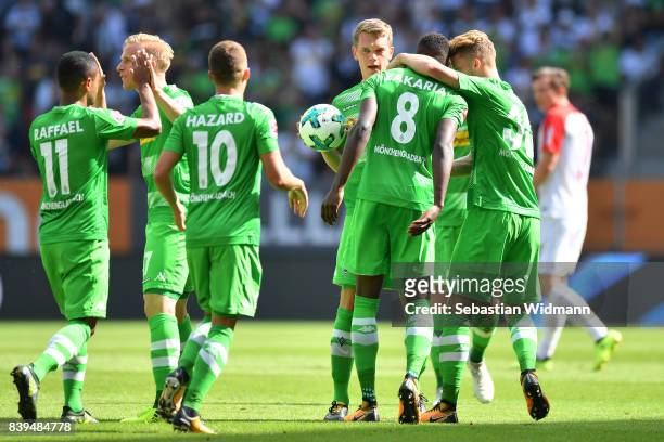 Denis Zakaria of Moenchengladbach celebrates with team mates after he scored to make it 1:1 during the Bundesliga match between FC Augsburg and...