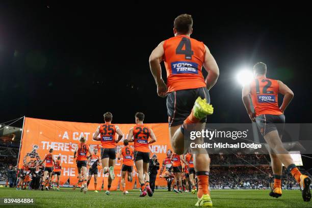 Phil Davis of the Giants waits for players to run to the banner during the round 23 AFL match between the Geelong Cats and the Greater Western Sydney...