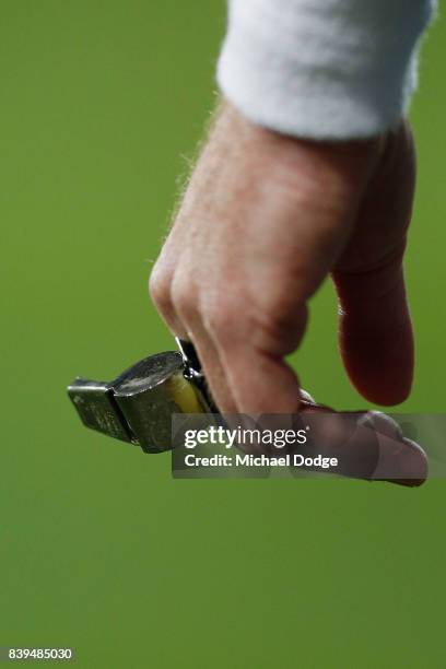 An umpire's whistle is seen during the round 23 AFL match between the Geelong Cats and the Greater Western Sydney Giants at Simonds Stadium on August...