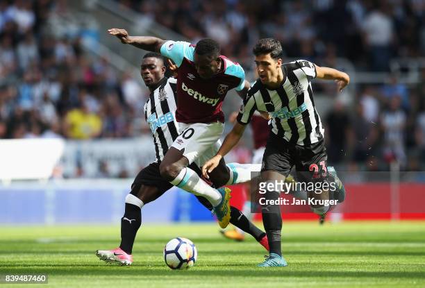 Michail Antonio of West Ham United and Mikel Merino of Newcastle United battle for possession during the Premier League match between Newcastle...