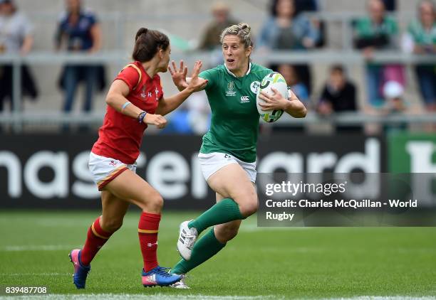 Alison Miller of Ireland is tackled by Jasmine Joyce of Wales during the Women's Rugby World Cup 2017 7th Place Play-Off match between Ireland and...